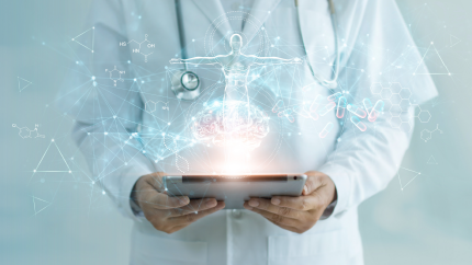 person in white labcoat holding tablet