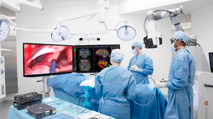 surgeons operating and looking at monitors