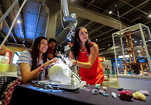 Sherrie Van Oss (right) of Synaptive Medical demonstrates BrightMatter technology at a OU Medicine event held at the Science Museum Oklahoma.