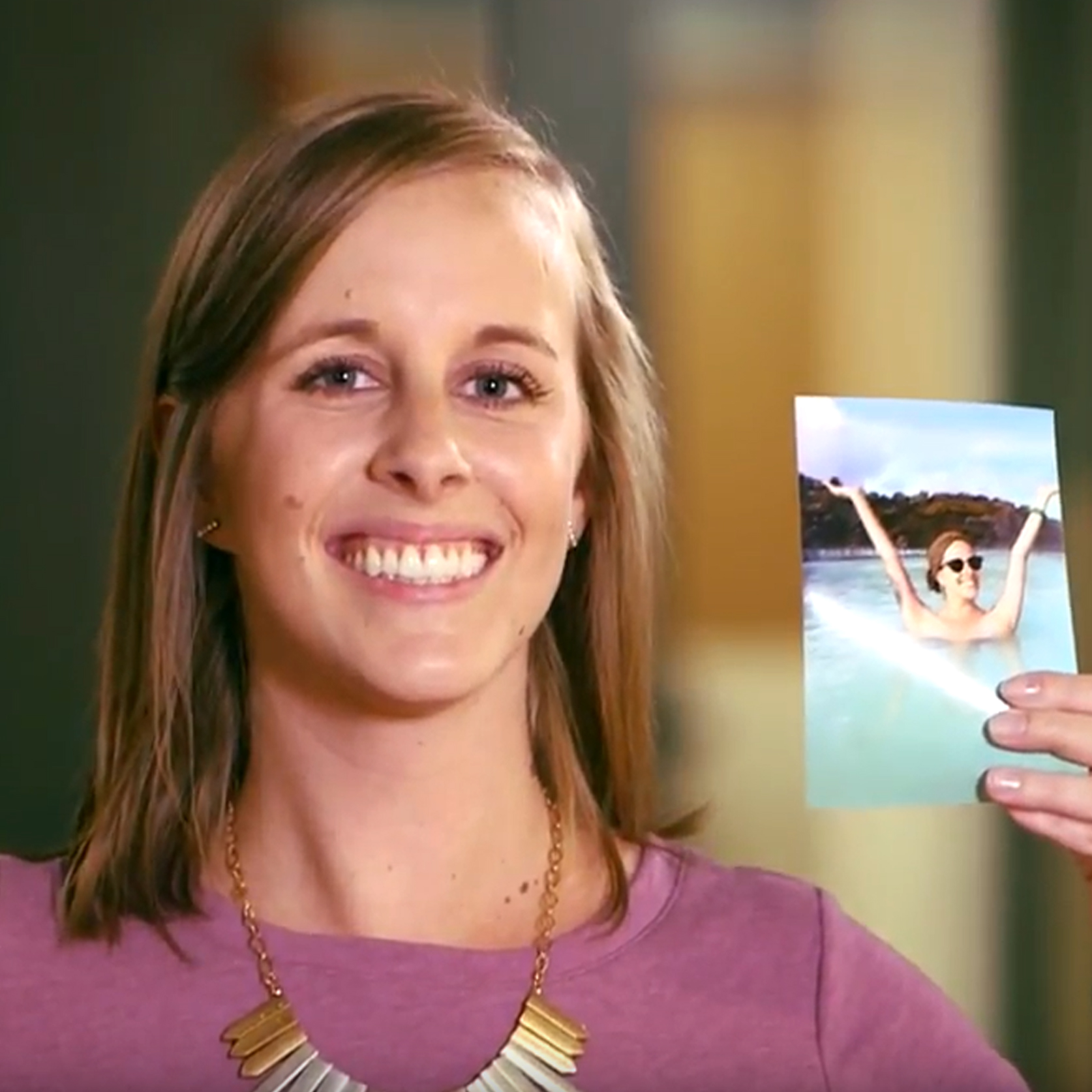 smiling woman holding a photo on her swimming