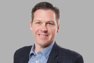 man in suit jacket smiling